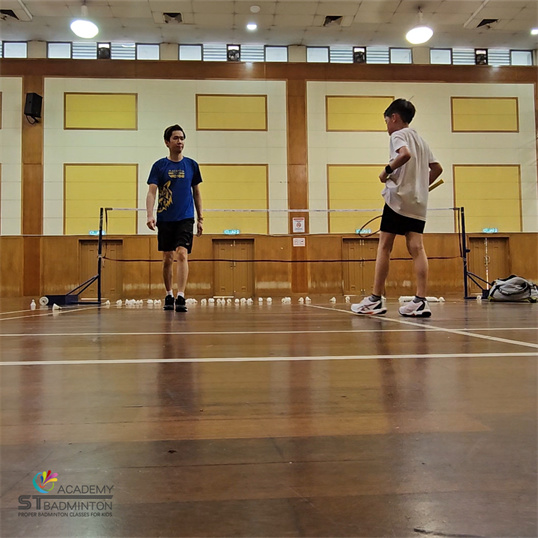 Badminton coach Taman Ibu Kota KL teaching proper techniques to children
