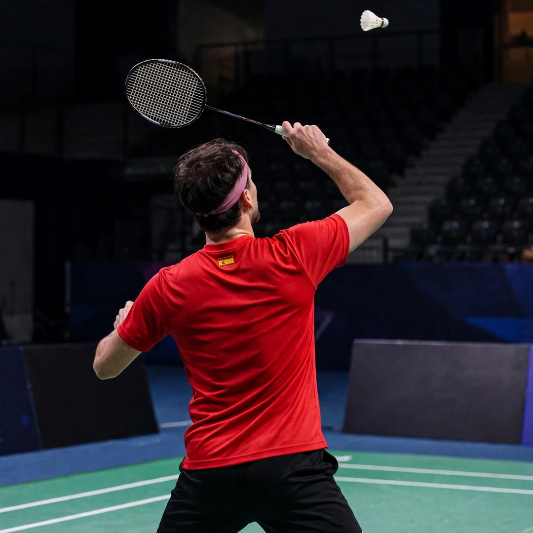 Alvaro Leal playing a backhand clear from the rear court (AI-generated) Alvaro Leal playing a backhand clear from the rear court (AI-generated)