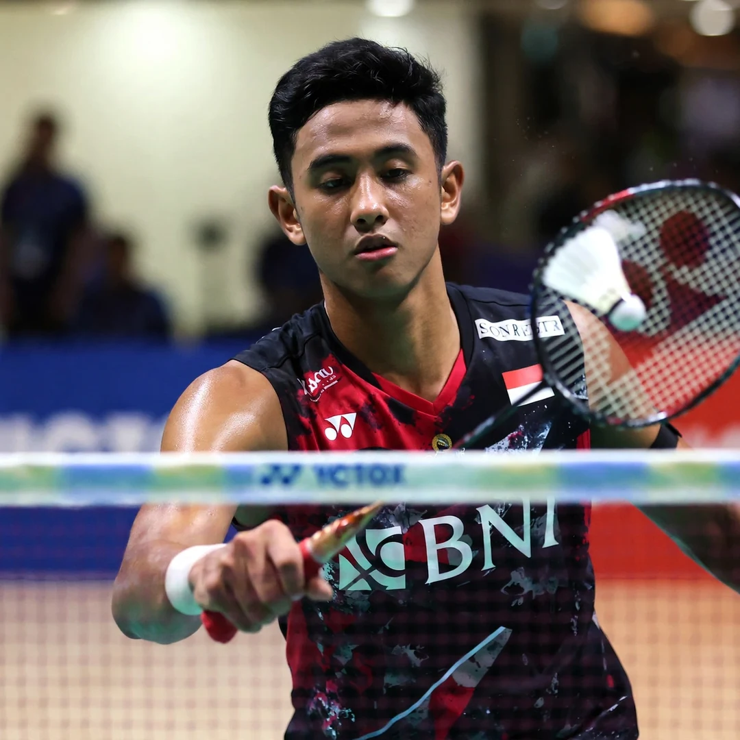 Alwi Farhan displaying net touch and finesse at the net Alwi Farhan spinning net shot at the tape (AI-generated)