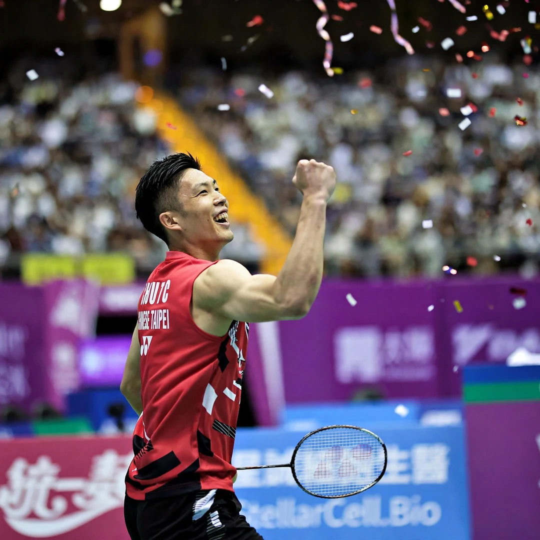 Chou Tien Chen celebrating world championship victory with Chinese Taipei flag display Chou Tien Chen celebrating victory (AI-generated)