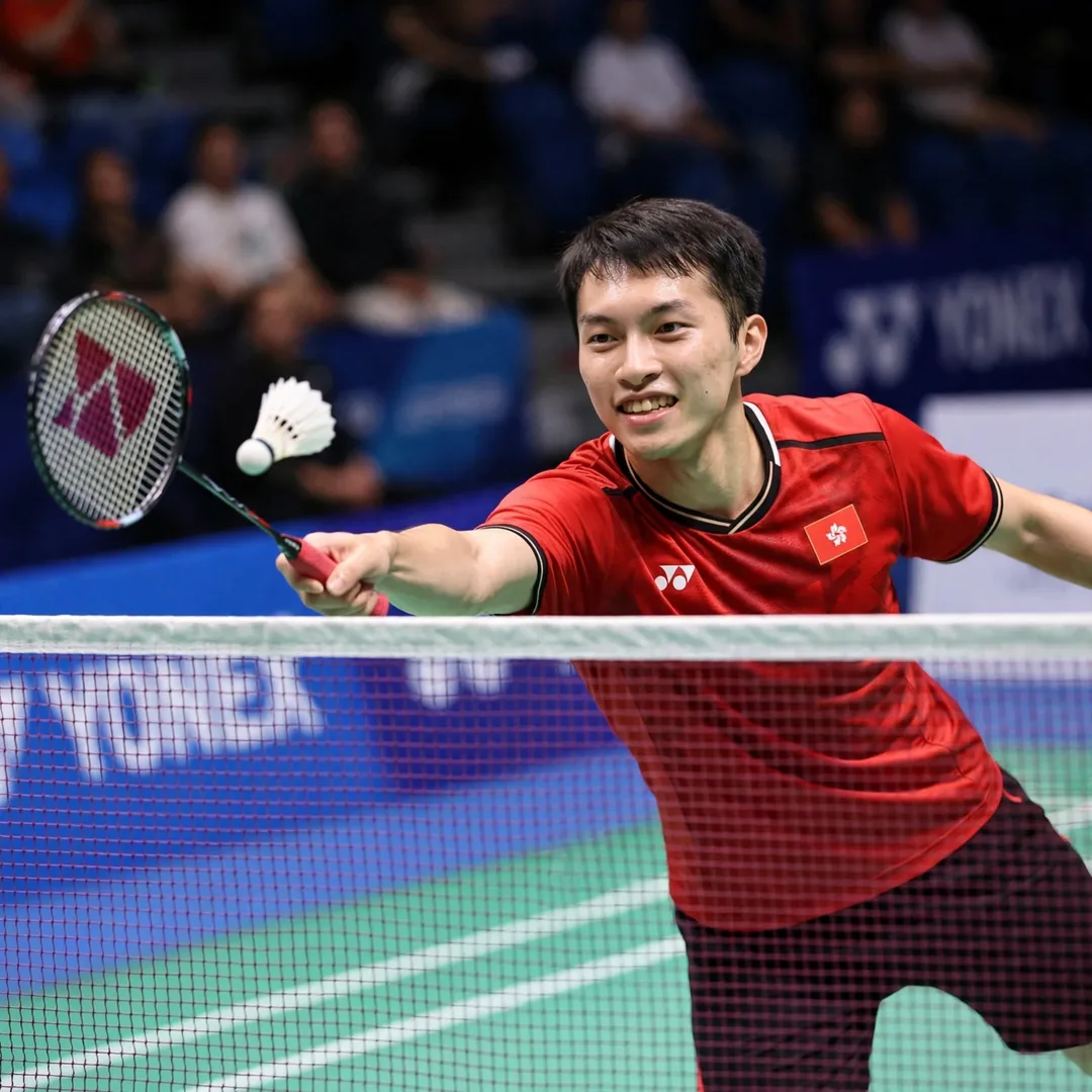 Ng Ka Long Angus net play technique Ng Ka Long Angus playing a tumbling net shot, racket in his right hand (AI-generated)