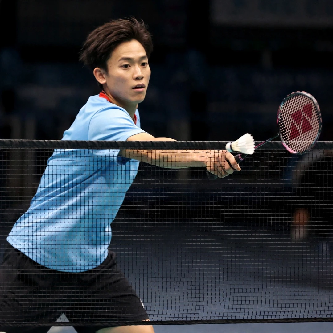 Riki Takei showing delicate net play during a long rally Riki Takei playing a spinning net shot, racket in his right hand (AI-generated)